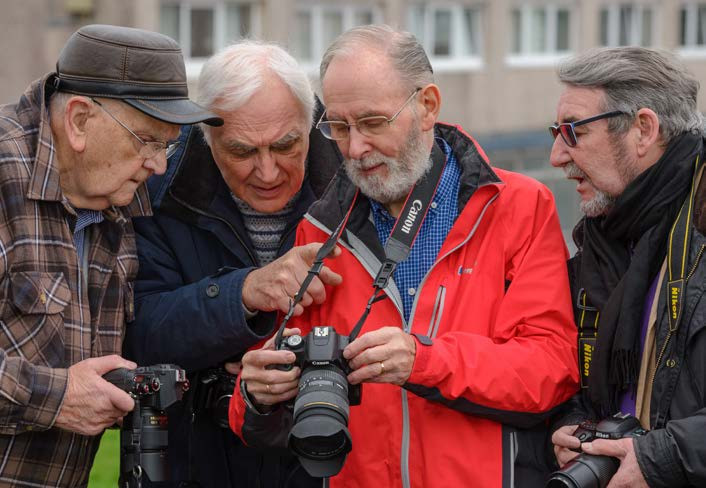 u3a members discussing a camera
