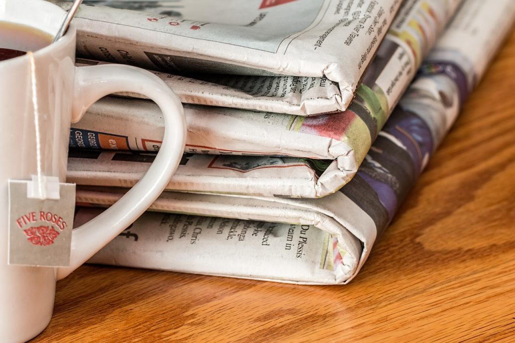 Teacup and newspapers on a table