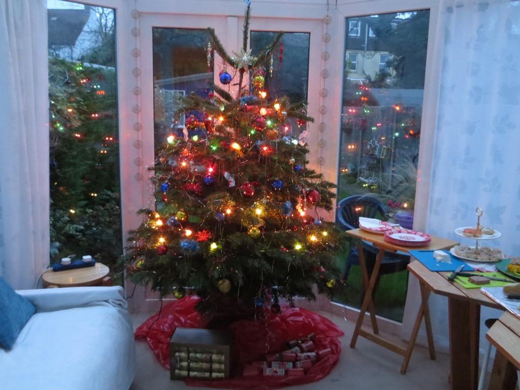 Table of food beside a Christmas tree