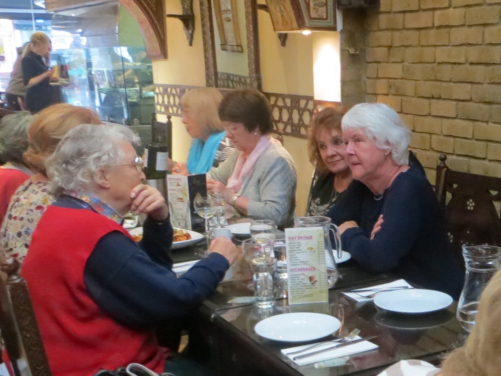 People seated at a table having a meal in a restaurant
