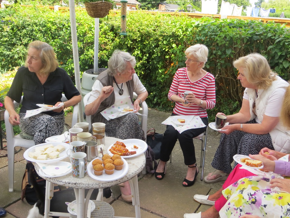 People seated around a table, eating and drinking