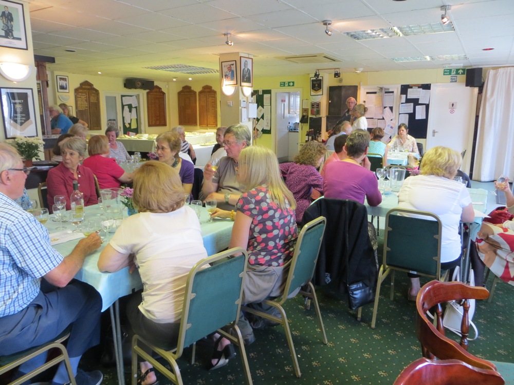 People seated at tables having a drink