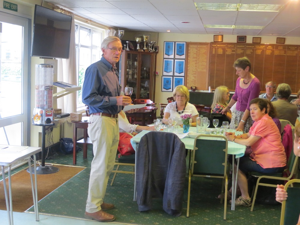 People standing and seated at tables having a drink