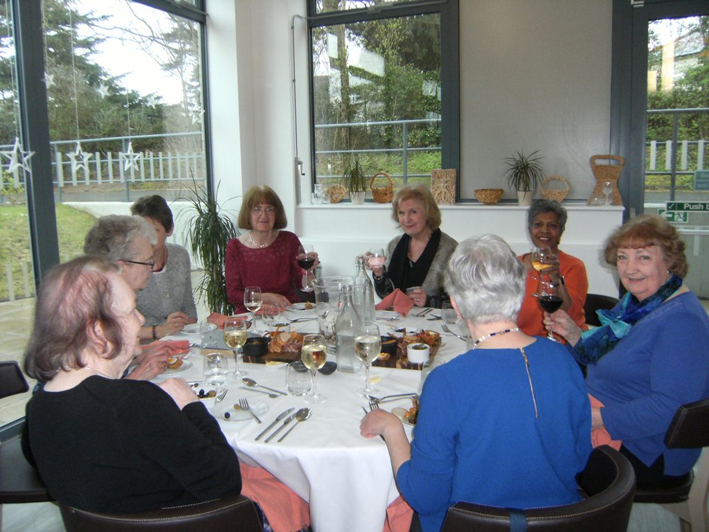 People seated around a table having a meal
