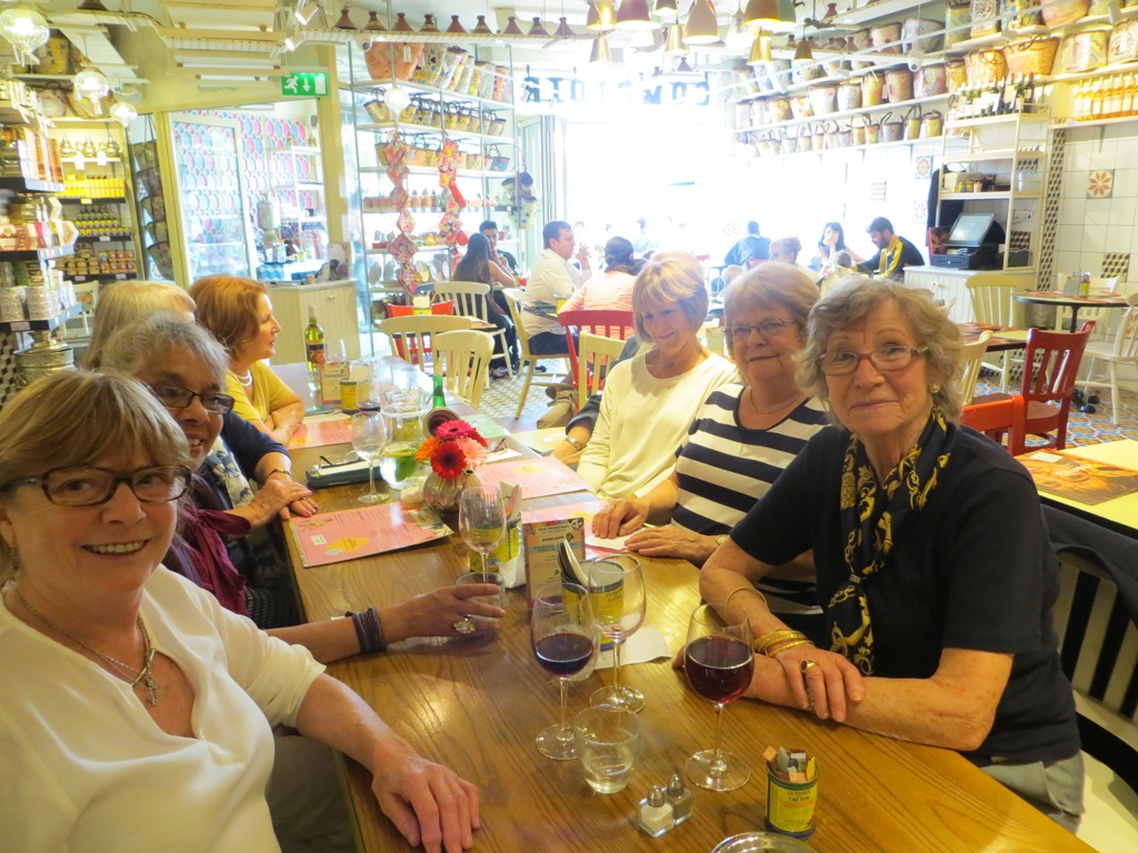 People seated at a table about to order a meal in a restaurant, posing for a photo