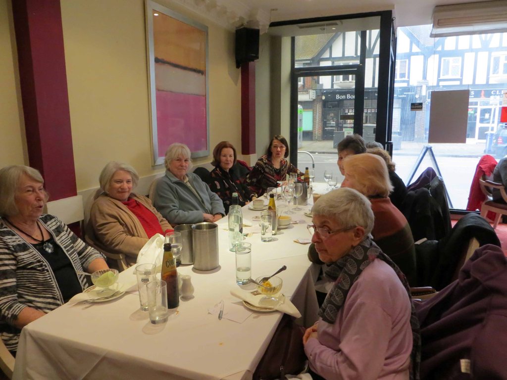 People, seated at a table, having a meal in a restaurant
