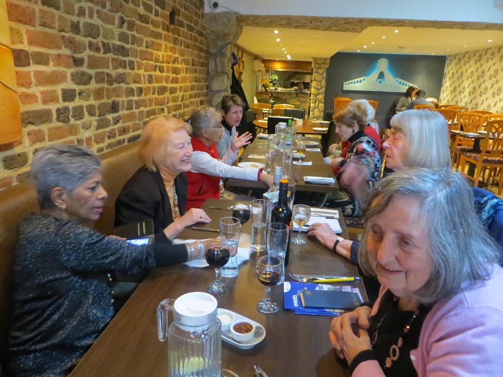 People seated at tables, having a meal in a restaurant